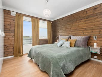 Spacious neutral-colored bedroom during daytime.