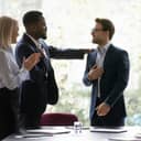 team applauding and celebrating a coworker's success during a meeting