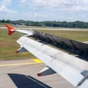 Close-up view from airplane window of wing and flaps