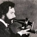 an actor portraying Alexander Graham Bell in a 1926 movie, holding Bell's original telephone transmitter