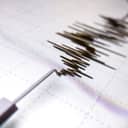 Richter scale Low and High Earthquake Waves with Vibration on white paper background, audio wave diagram concept, photo of cellphone screen, Aceh Indonesia