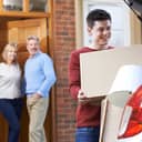 Parents standing at the door as their adult son moves out of the family home.