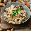Bowl of risotto with mushrooms and fresh basil