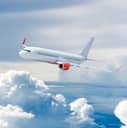 Passenger airplane flying above the clouds