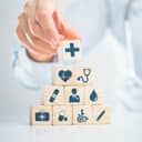 Stacked wooden blocks with healthcare-related icons
