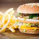 Hamburger and fries on a wooden plate