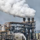 Thick smoke coming out of industrial chimneys in a refinery