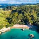 Aerial view of a secluded coastline with tiny bays in Coromandel, New Zealand.