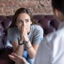 Portrait of a young woman seeking help from a therapist or counselor.