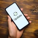 Person hand holds smartphone after system update.