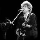 Portrait of Bob Dylan playing guitar, from the Santana and Bob Dylan concert in Barcelona, 1984.