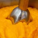 Close-up of a blender creating smooth pumpkin puree.