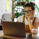 Young woman working on her laptop indoors