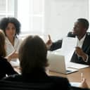 businessman disputing contract terms while pointing at a document during a meeting in the office