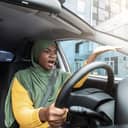 A woman in a car annoyed at the traffic.