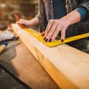Woman taking carpentry measurements