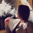 Woman vaping indoors