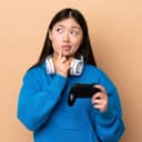 Woman deep in thought holding a video game controller