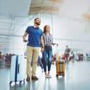 Couple at an airport terminal ready to travel