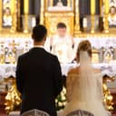 Wedding couple in front of a priest at the altar