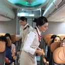 flight attendants talking with passengers on board