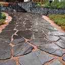 Close-up of an elegant slate pathway that provides access to a modern house.