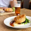 Pie and mash with gravy, green vegetables and a pint of ale