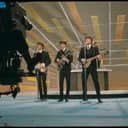 The Beatles entertaining the audience with their performance on The Ed Sullivan Show in 1964.
