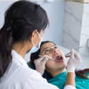 close-up of a female dentist examining her female patient at a dental clinic