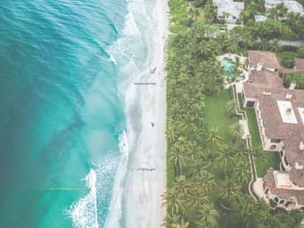 Bird's eye view of a house at the beach.