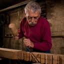 Elderly woodcarver at work in the workshop