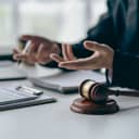 A closeup of a judge and a gavel on the table