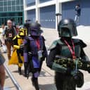 A group of fans dressed in Mandalorian-inspired costumes at Star Wars Celebration IV.