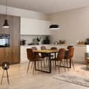 modern open-plan kitchen interior with a dining table and lamps