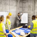 An architect talking with a group of civil engineers