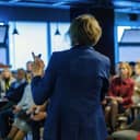 Female presenter speaks to audiences at workshop
