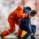 Rescue worker helping an injured person to safety