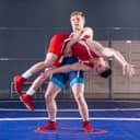 Two male wrestlers practicing in the ring