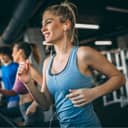 Woman wearing earphones running on the treadmill