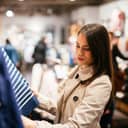 Young woman browsing items while shopping