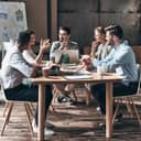 A group of co-workers sitting at a table having a meeting