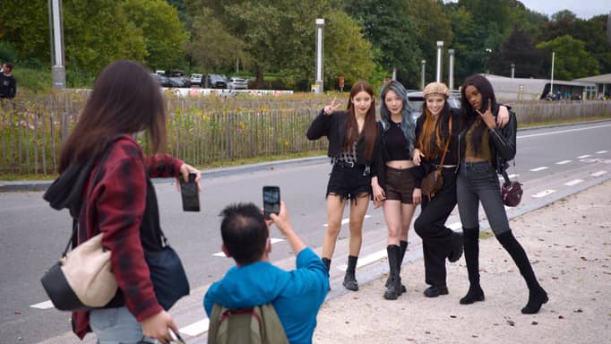 In this undated photo provided by AppleTV+, K-pop band Blackswan members have their photos taken. 