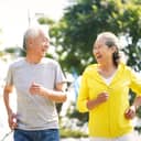 happy asian old couple jogging running outdoors in park