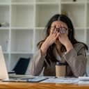 young businesswoman feeling exhausted from prolonged desk work