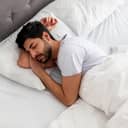 Young man sleeping soundly in a comfortable bed