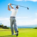 Man playing golf out on the course