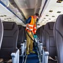Maintenance worker cleaning the airplane cabin