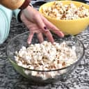 woman cooking popcorn at home to watch a movie