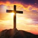 Cross on a hill at sunset