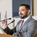 A charismatic man talking at a press conference